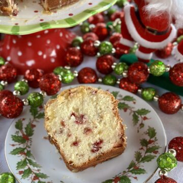 A slice of cranberry orange pound cake on a saucer.