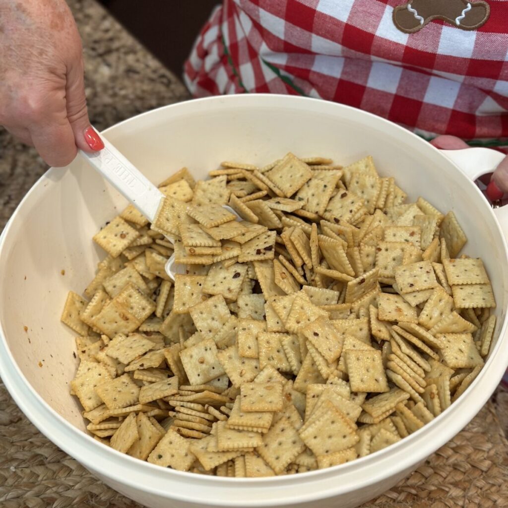 Mixing crackers in a bowl with crackers.