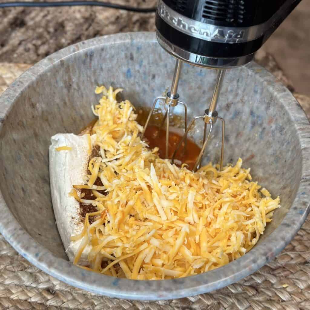 Blending together the ingredients in a bowl for Nashville hot chicken dip.