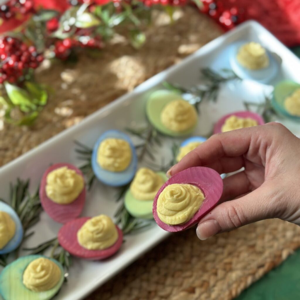 Holding a Christmas deviled egg.