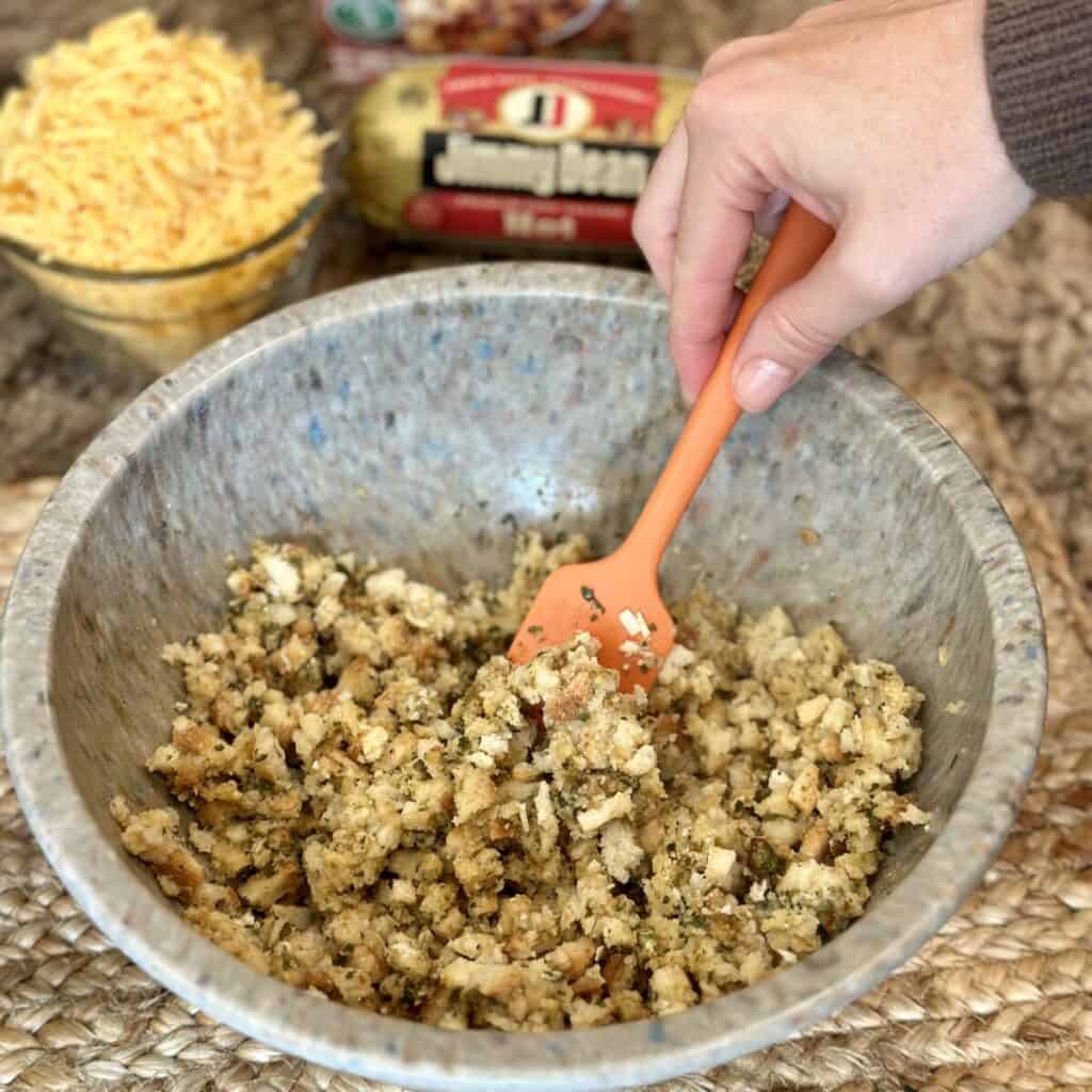 Mixing together stuffing and water in a bowl.