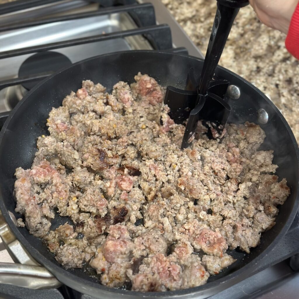 Browning sausage in a skillet.